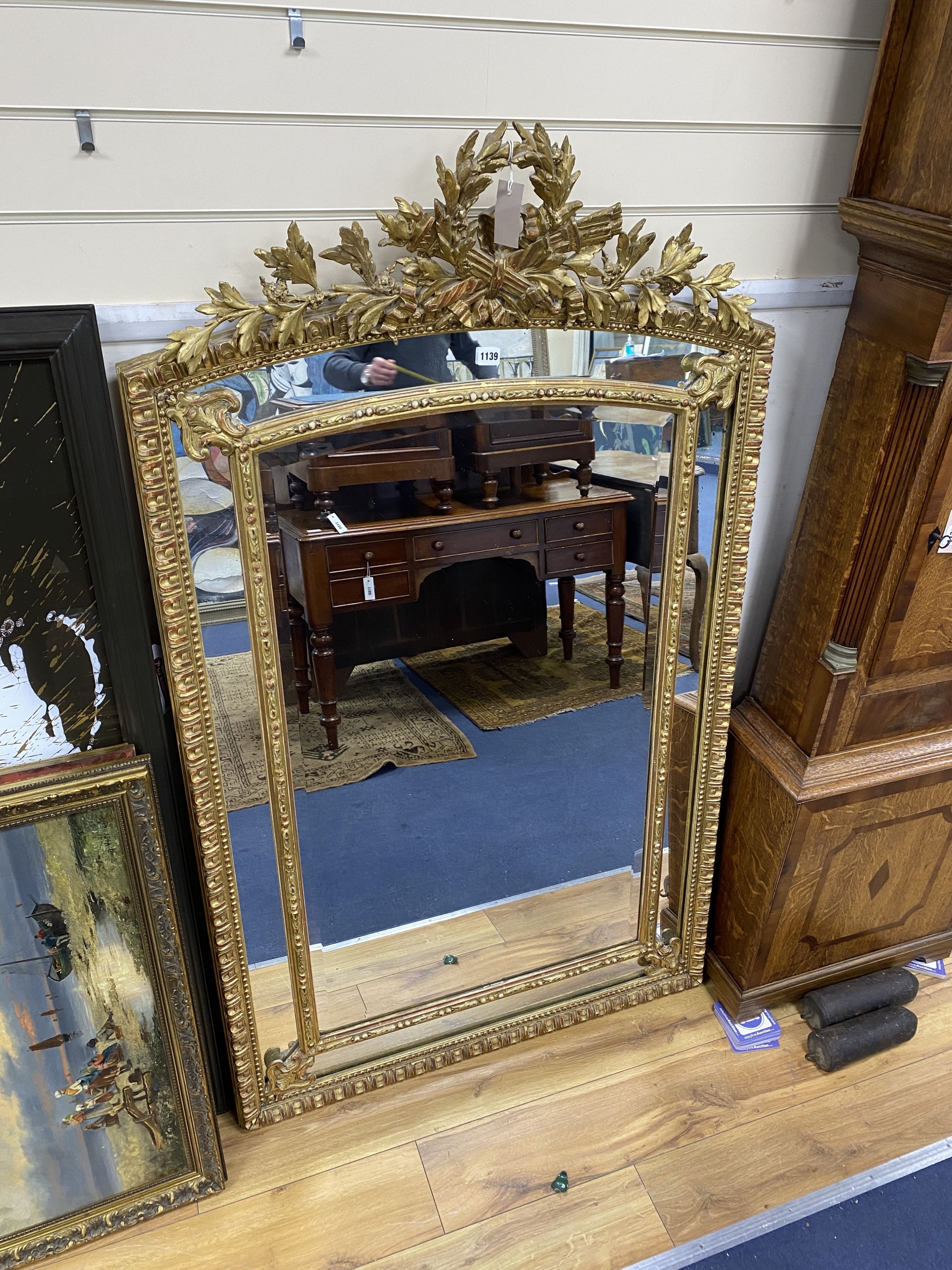 A 19th century giltwood and gesso overmantel mirror with Olympic Torch & Laurel Crown, side cushions with decorated bead detail, width 92cm, height 153cm